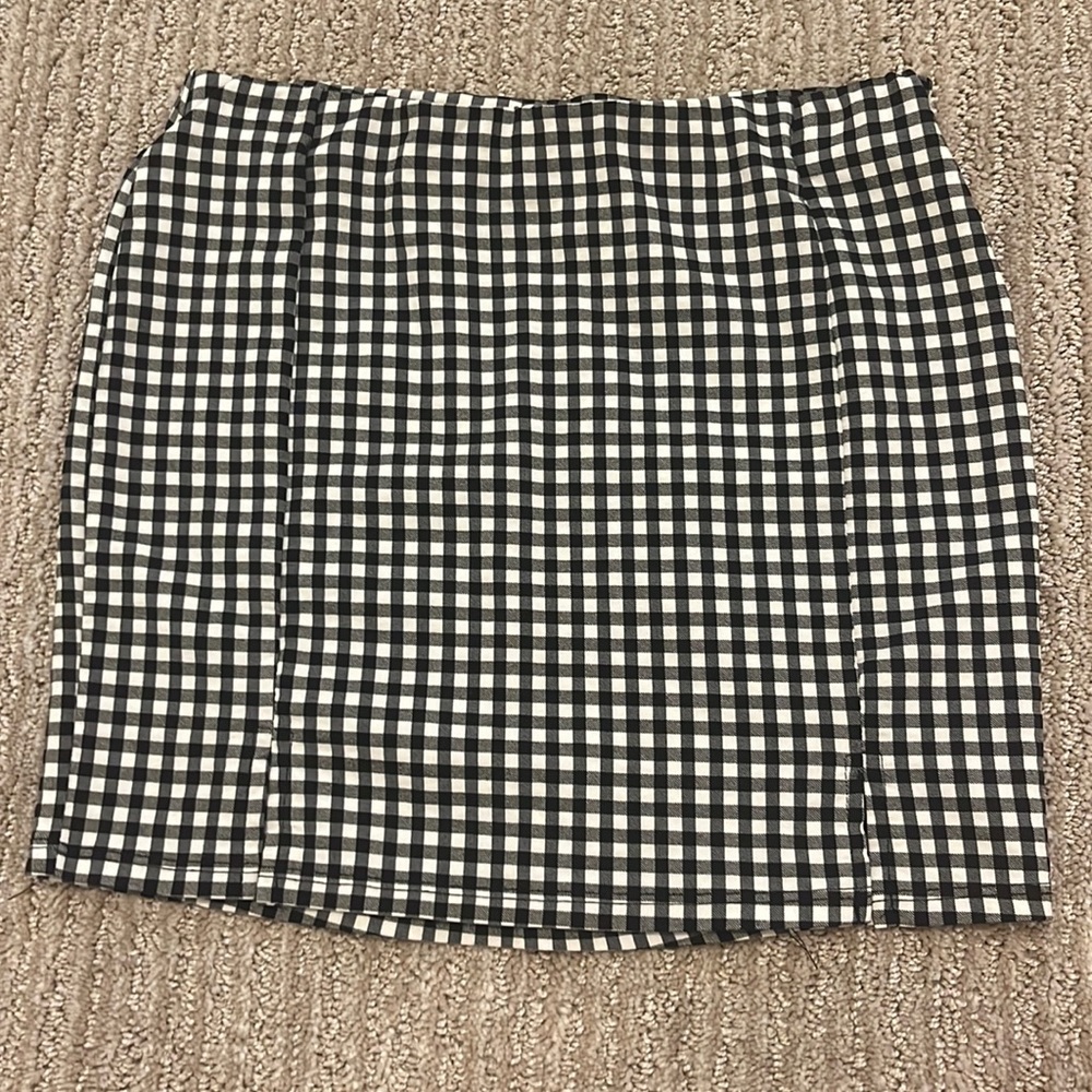 I am selling this super cute plaid skirt with 2 cut outs on the bottom.